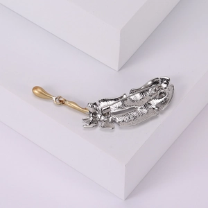 Minimalist silver and gold feather brooch pin for coats with sleek metallic finish