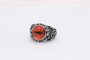 Detail macro of vintage gothic bat ring with a striking red dragon eye gemstone inlay
