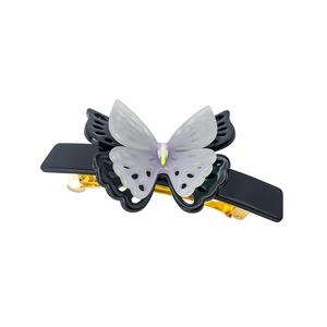 Close-up of double-layered butterfly hair claw clip with gradient colors and center rhinestone