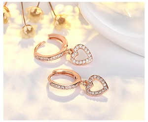 Close-up of elegant rose gold heart earrings with sparkling pavé-set stones