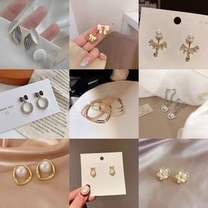 Collection of various earrings with pearls and butterfly designs in gold and silver finishes