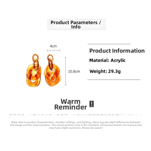 Detail view of amber acrylic chain earrings showing 10.8cm size and 29.3g weight