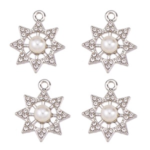 Detailed view of silver star charms with white pearls and sparkling cubic zirconia crystals