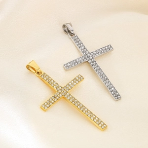 Close-up of gold and silver hip hop cross pendants with crystals on silk background