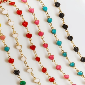 Macro shot of colorful enamel heart pendants on gold stainless steel chains in various colors