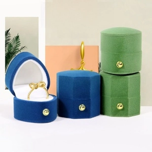 Detailed view of octagon velvet jewelry boxes with snap buttons for ring storage