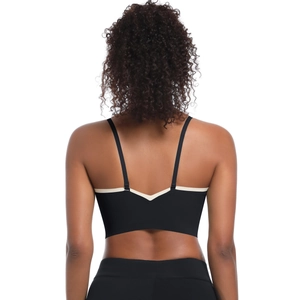 Detail of cross back sports bra featuring V-cut design and cream contrast trim