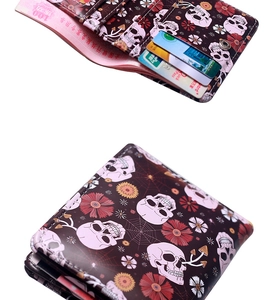 Detail of spider skull wallet with card slots and bill compartment on white background