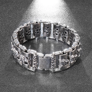 Close-up of vintage wolf head engraving on silver stainless steel biker bracelet