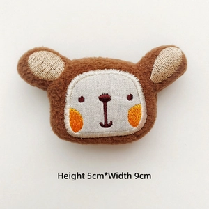 Detailed view of brown plush bear head with embroidery, size H 5cm and W 9cm