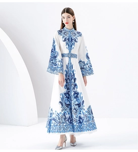 Detail of elegant white long dress with blue Paisley print and floral lace stand collar