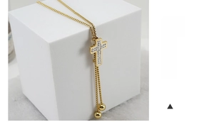 Detail of adjustable 18K gold plated cross pendant necklace with micro-pave zircons