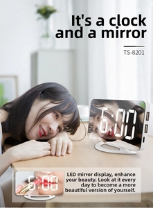 Detail of LED mirror clock showing USB charging ports and large digital display screen