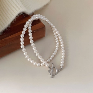 French style 925 sterling silver pearl necklace with metal toggle clasp on wood base