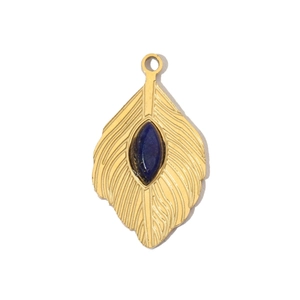 Close-up of golden feather pendant with an oval blue natural stone in a vintage style