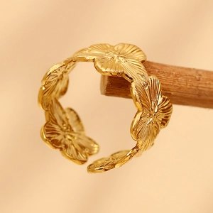 Retro 18K gold plated stainless steel floral open ring displayed on wooden stand