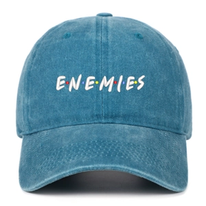 Close-up of blue washed denim baseball cap with white ENEMIES embroidered text