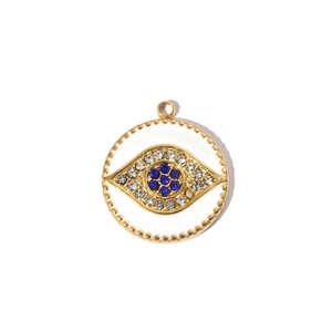 Detailed view of evil eye gold pendant with white enamel and blue rhinestone inlay