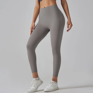 Detail of high waisted dark gray yoga pants featuring ergonomic side stitching and wide waistband