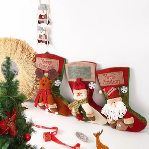 Three large vintage Christmas stockings featuring Santa, Snowman, and Reindeer designs