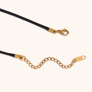 Detailed macro view of 18K gold plated lobster clasp and extension chain on black necklace