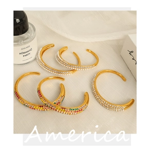 Detail of 5-piece gold cuff bracelet set with colorful rhinestones and pearls