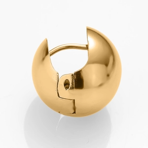 Macro shot of polished gold spherical huggie earring with a smooth hinge closure