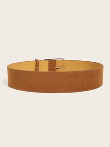Macro detail of brown suede wide belt showing smooth leather lining and silver buckle