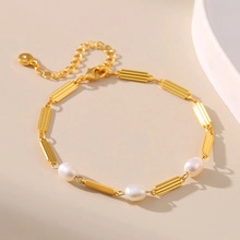 Detail of freshwater pearl bracelet with rectangular textured gold links and lobster clasp