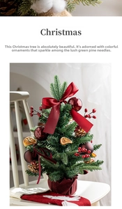 Detailed view of a mini Christmas tree with red bows, berries and dried orange slices