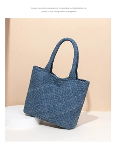 Detailed view of blue woven denim texture and craftsmanship on a large tote bag