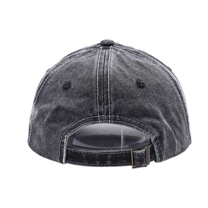 Detail view of washed denim baseball cap with vintage finish and metal buckle strap