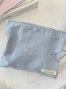 Light blue star sequin makeup bag with silver patterns and Sorakka brand label