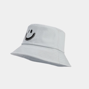 Close-up of light gray cotton bucket hat with black smiley face print and stitched brim