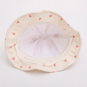 Detail view of baby sun hat showing breathable white mesh lining and windproof strap