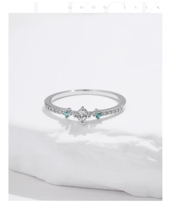 Detail of s925 silver ring with blue gems and sparkling center zircon on stone base