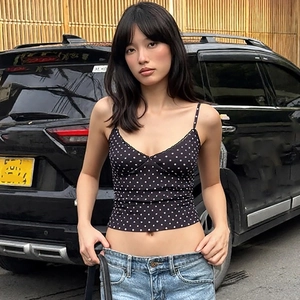 Detail shot of slim fit polka dot camisole with thin straps and V-neckline