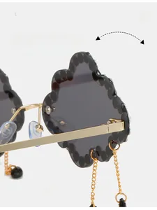 Detail of durable gold metal hinge on cloud-shaped sunglasses with gray lenses