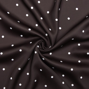 Detailaufnahme von dunkelbraunem Stoff mit weißen Punkten, weiche Textur und schöner Fall