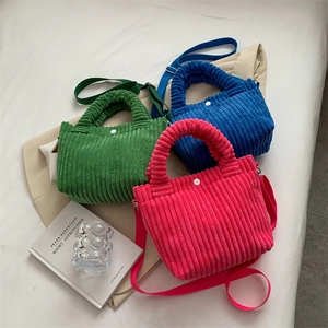 Chic corduroy bucket bag in green, blue, and pink colors with adjustable shoulder straps