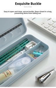 Inside view of open light blue pencil case showing divider compartments and scale marks
