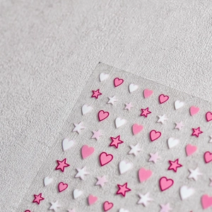 Macro shot of cute pink heart and star nail art stickers for DIY manicure decoration