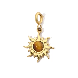 Detail of golden sunburst pendant with tiger eye stone and secure lobster clasp