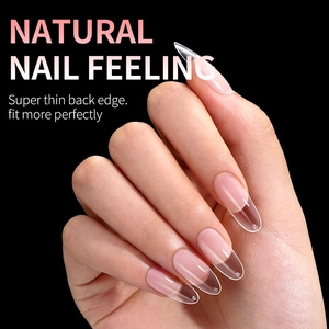 Oval transparent false nail tips with thin edges for a natural fit on a black background