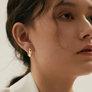Minimalist gold geometric C-shaped ear cuff with textured hammered finish for women