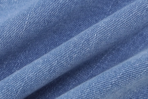 Macro shot of light blue denim fabric texture and cotton twill weave of the skirt set