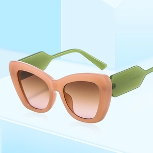 Fashion cat eye sunglasses with orange pink frames and green temples for women
