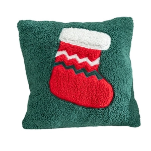 Dark green Christmas throw pillow with red and white embroidered stocking decoration