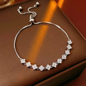 Detailed macro view of sparkling zircon clover bracelet with adjustable slider clasp