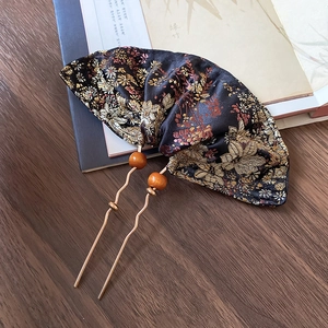 Detail of embroidered floral silk fan on metal hair pin with amber wooden beads